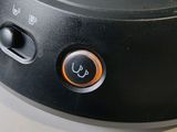 a close up of a black speaker on a table