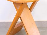 an image of a small wooden table with a wooden cross leg