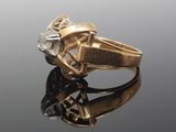 an image of a gold ring with a diamond on it
