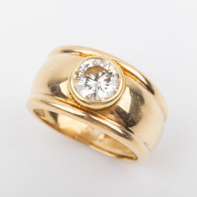 a close up of a gold ring with a diamond in the center