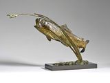 bronze sculpture of a fish on a stand with a flower in its mouth