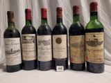several bottles of wine are lined up on a table