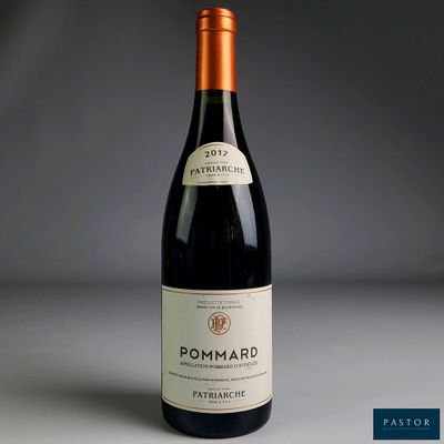 a picture of a bottle of red wine on a table