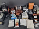 a lot of old cameras and other items on the table