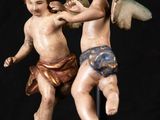 statue of two cherenskers fighting each other on a black background
