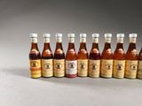 six bottles of beer lined up in a row on a table