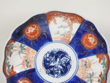 a blue and white plate with orange designs on it