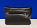 a black purse sitting on top of a white table