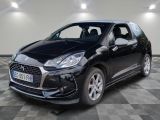 la voiture noire est garée sur un sol en damier dans le garage