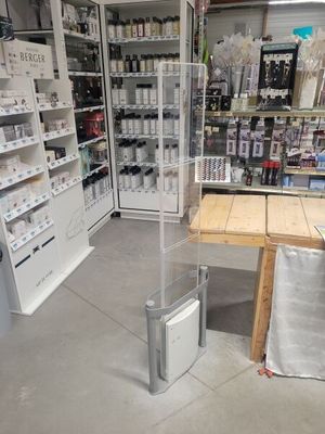 a table in the middle of a store with a lot of items on the shelves
