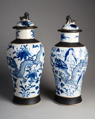 pair of blue and white vases with birds and flowers on them