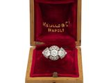 a diamond ring in a wooden box on a white background