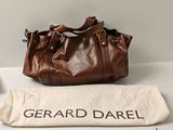 the large brown bag is sitting next to a white bag