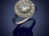 a close up of a diamond ring on a blue surface