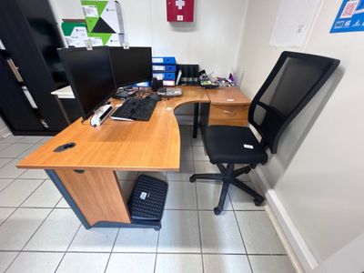 a desk with a chair and a computer on it