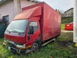 a red truck that is parked in the grass