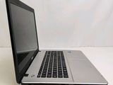 an open laptop computer sitting on top of a white table