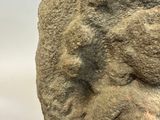 a stone statue of a man with a beard and a mustache