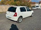 a small white car parked on the side of the road