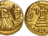a gold coin with an image of a woman holding a cross