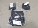 three bags of clothing on the floor next to each other