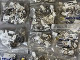 many different types of screws in bags on the table