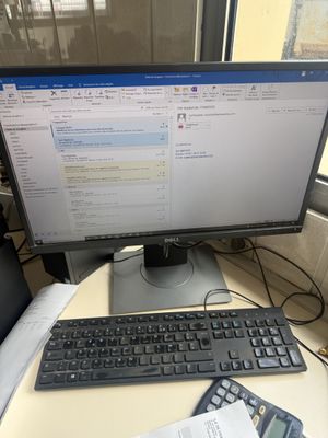 a desk with a computer and a calculator and a calculator