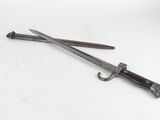 a close up of a knife and a pair of scissors on a white surface