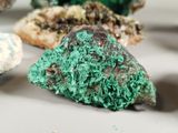 many different colored rocks on a white surface