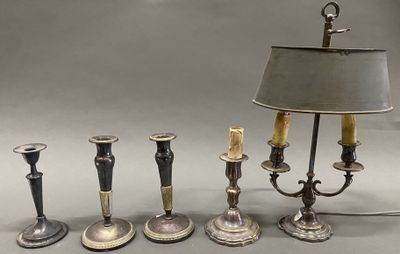 five candles that are sitting next to a lamp on a table