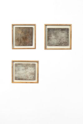 three framed photographs of a man sitting on a bench in front of a white wall