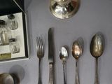 a lot of silver spoons and silverware on the table