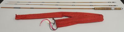 a lot of fishing rods and a pair of pants on a table