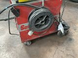 a machine that is sitting on a cart in the garage