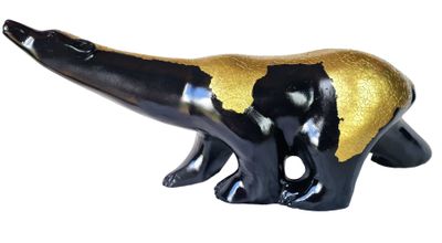 a black and gold dinosaur figurine on a white background