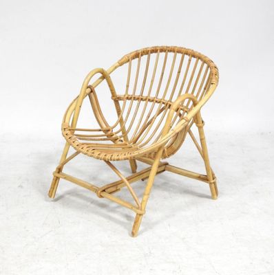 an image of a chair made out of bamboo with a white background