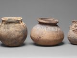 three vases with faces on them are sitting next to each other