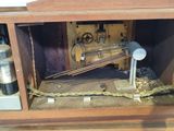 a small wooden box with a clock inside of it