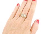 an image of a woman ' s hand with a yellow and white diamond ring