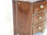 a marble top chest of drawers with brass handles