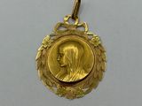 a close up of a gold medal on a white surface