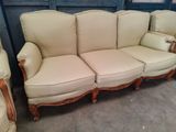 a couch and two chairs that are in a room