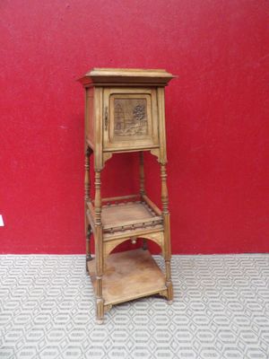 a small wooden shelf with a shelf on it in front of a red wall