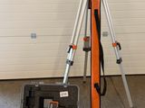 a tripod and a camera in a case in a garage