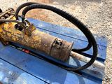 a rusted pipe sitting on top of a blue bench