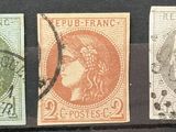 four different colored stamps on a black surface with a woman ' s head in the center
