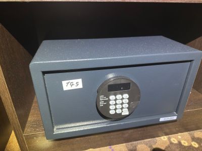 a safe box that is on a shelf in a room