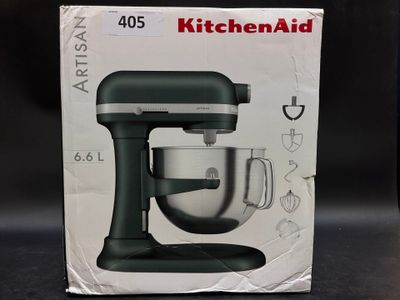 packaging of a kitchenaid mixer sitting on a table in front of a black background