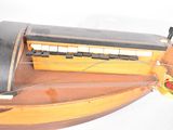 a wooden model of a boat with a hamburger on it