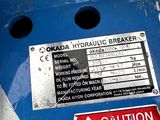 a sign on the side of a blue machine that says caution